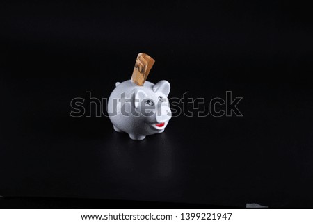 White pig savings bank on a black background. 