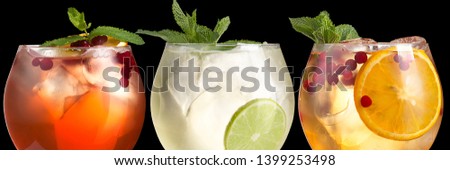 Delicious alcoholic trendy cocktails with fresh berries on a black background. Wide format banner. Macro.