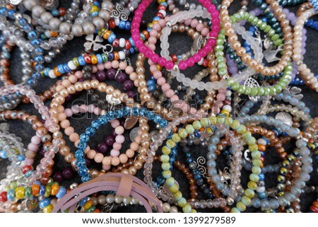 Many colorful necklaces and bracelets