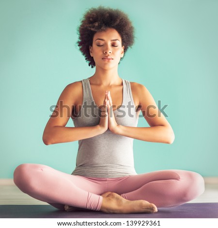 Young African woman in the prayer position. Royalty-Free Stock Photo #139929361