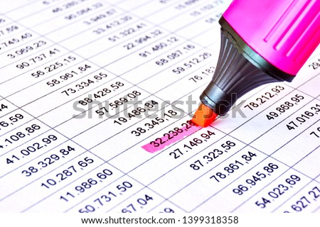Red pink marker on a sheet of paper with printed financial numerical data table and marked numbers. Concept for accounting, budget, profit, tax and financial review. Image with selective focus      Royalty-Free Stock Photo #1399318358
