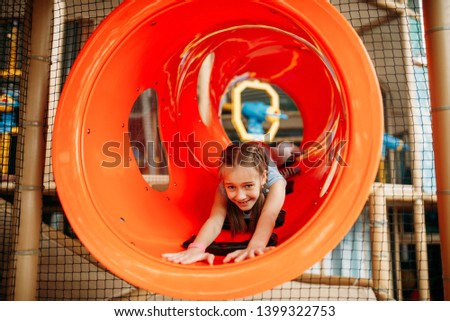 Girl climbing the maze in children game center
