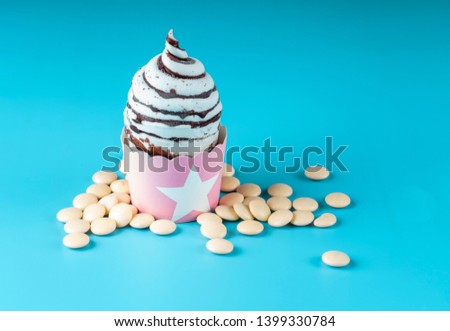 ice cream in the form f chocolate flavor and cream in blue background
