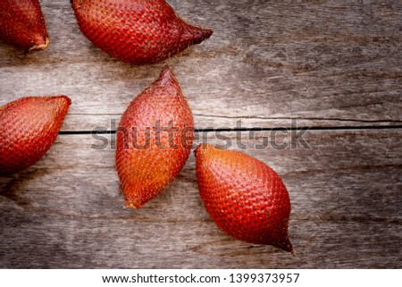 Salacca(Zalacca ,snake fruit) isolated on old wooden table background.Benefit for health such as fiber, vitamin c,antioxidant and mineral. Superfood concept. Vintage tone. Copy space for your text.
