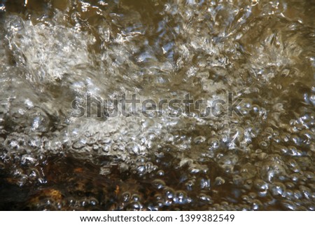 Water flow and Sponge in the river stream of natural waterfall.