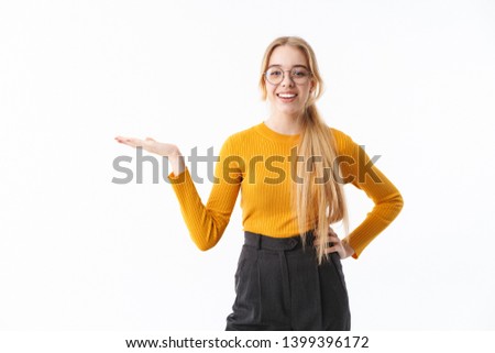 Attractive young blonde woman wearing sweater standing isolated over white background, presenting copy space