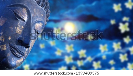 Face of buddha with moon abstract background.close up