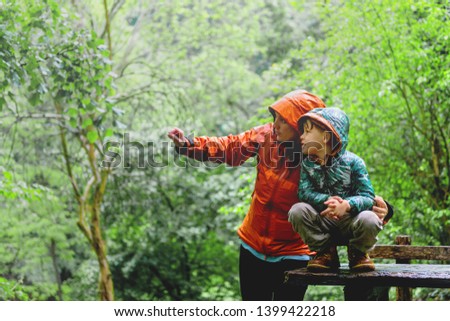 Mother and son exploring the nature