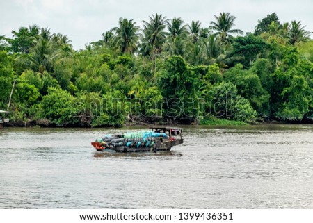 Boat transporting agricultural product on the Mekong River. Vinh Long, Vietnam, Mekong delta.