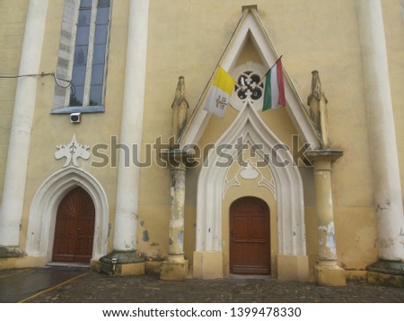 flag on Hungary and church entrance door