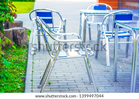 Empty chairs in outdoor cafe or restaurant on summer day