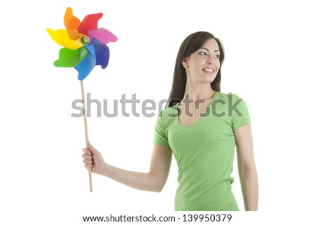 Young woman holding a pinwheel; green concept