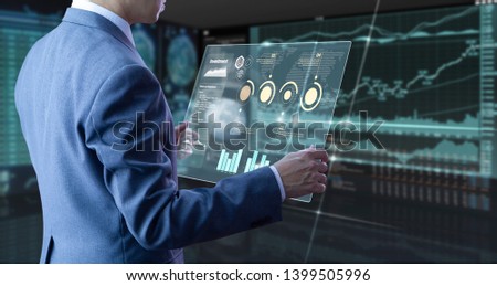 Businessman holding a modern tablet touch screen analysing on investment risk managment and return on investment analysis