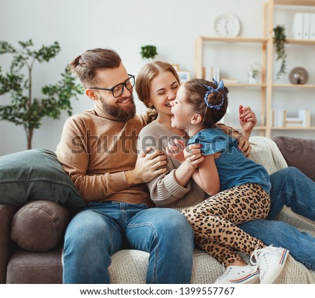 happy family mother father and child daughter laughing and havig fun at home  
