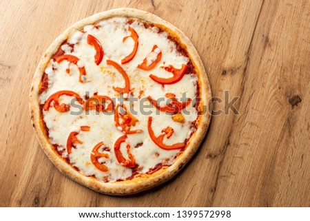 Pizza Margherita on wooden background, top view. Pizza Margarita with Tomatoes and Mozzarella Cheese close up. 