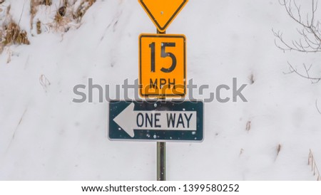 Panorama Road signs against snow covered slope in winter
