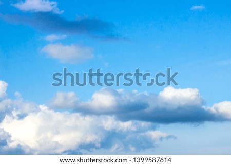 Beautiful gloomy blue sky with fluffy clouds in summer morning peace day as a background. Gray, white and turquoise color blured skyline photography