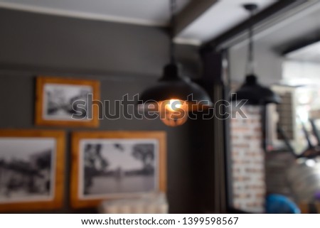 ฺBlur image - Defocus or out of focus black lamp on the ceiling, Living corner in the restaurant during the daytime, Blurred image background