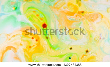Multicolored background with oil on liquid. Abstract golden green background on liquid. Pattern with multicolored spots. Fluid art