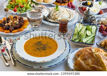 Traditional Turkish Ramadan,iftar dinner table with soup,chicken,rice,salad,dry and fresh fruits and sliced Ramadan Bread.