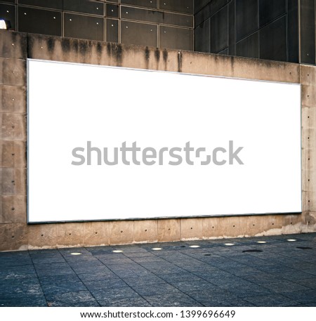 Large blank horizontal advertising bilboard mockup in city or town. Copy space. Royalty-Free Stock Photo #1399696649