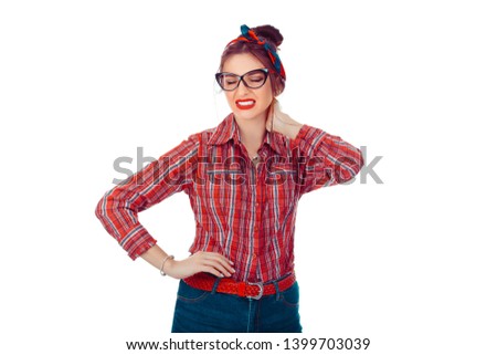 Tired woman having pan in neck. Closeup portrait of a beautiful girl in red checkered shirt and jeans with retro bow on head isolated on pure white background. Mixed race, hispanic, caucasian model