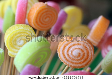 Colorful candy with sticks closeup. Colorful candy texture background. Rainbow candy colors at children's birthday party.