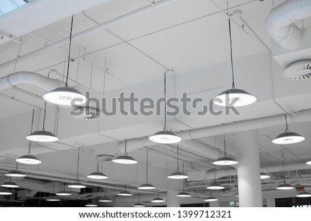Shopping center led lighting. Ceiling lights in the mall. Ventilation and water pipes. Fire alarm system Royalty-Free Stock Photo #1399712321