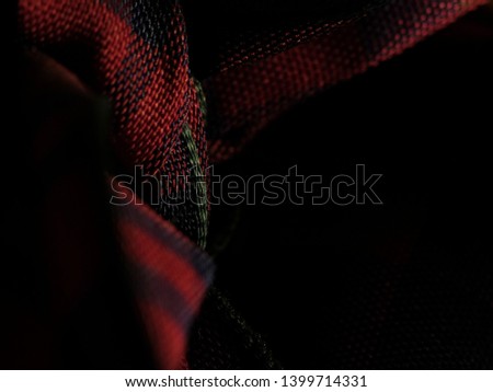 Tartan scarf in a dark room