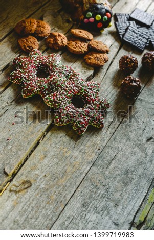Retro aged wooden board with chocolate chip cookies and candy in a corner with space for text