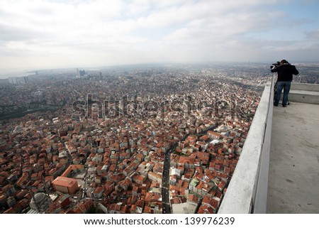 Cameraman, working on top of a skyscraper in Istanbul, Turkey.