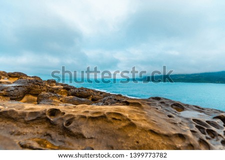 Beautiful seaside stone under the gloomy sky background. holiday concept. BEIJING, CHINA. decoration image contain certain grain noise and soft focus.
