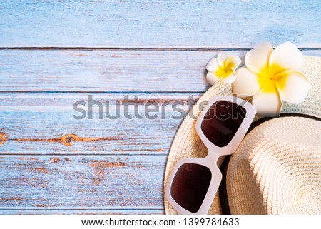 Beautiful summer holiday, Beach accessories, sunglasses, hat and flower on wooden backgrounds