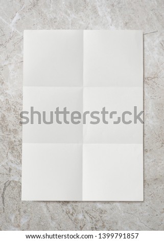 Folded paper crease on marble background