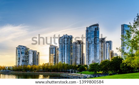 Sunset as the sun is setting behind modern Skyscapers lining the skyline of Yaletown along False Creek Inlet of vancouver, British Columbia, Canada Royalty-Free Stock Photo #1399800584
