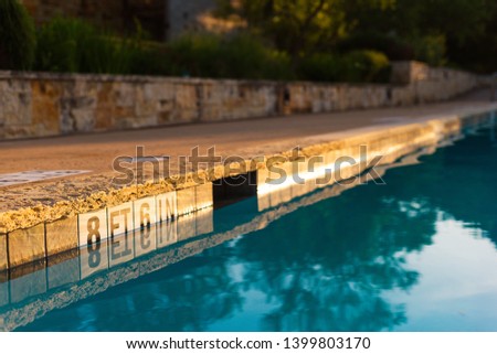 calm swimming pool in golden sunset/sunrise (no diving) Royalty-Free Stock Photo #1399803170