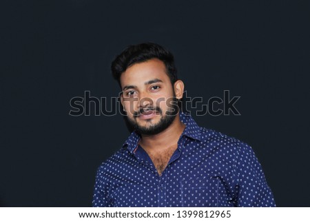 portrait of a handsome smart young man model with black background isolated
