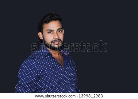 Portrait of a handsome young man model with black background isolated casual dress