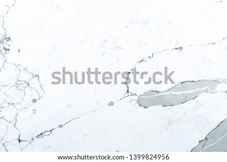 Flat background slate of polished marble used for construction, or a backdrop design. Marble pattern is mostly white, black and grey.