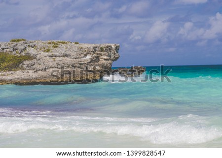 Sea waves crashing over rocks on beach in Coya Coco, Cuba. Cloudy sky summer sea with sunlight. Tropical sea relax - Image