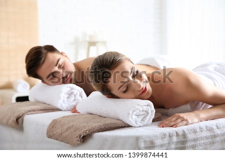 Romantic young couple relaxing in spa salon Royalty-Free Stock Photo #1399874441