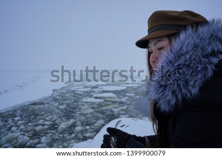 Fusion dressing up. Winter fur coat topped with Greek sailor hat has created memorable picture of cruising experience through frozen Baltic sea.