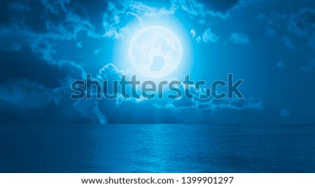 Night sky with full moon in the clouds "Elements of this image furnished by NASA