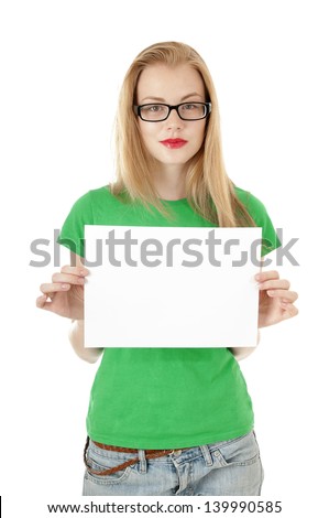 Pretty young girl showing empty blank  paper sign for text. Cute girl wearing glassed and green tee-shirt on white background.