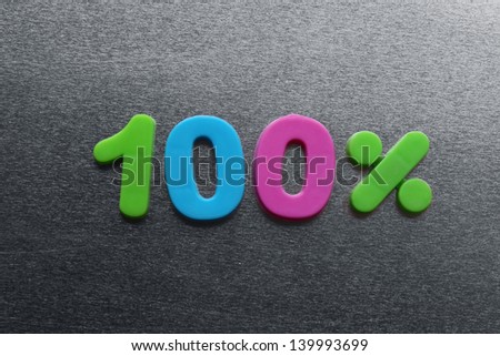 100 percent spelled out using colored fridge magnets