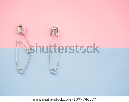 Several safety pins of various sizes in human representation. Concept of traditional family with children