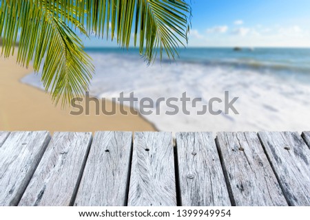 Wooden desk or plank on sand beach in summer. background. For product display.