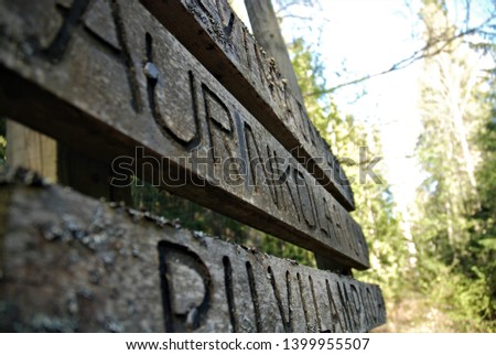 Board sign in a forest