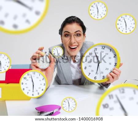 Young woman can't wait to go home from the nasty office. Holding the clock and waiting five minutes before the end. Concept of office worker's troubles, business or problems with mental health.