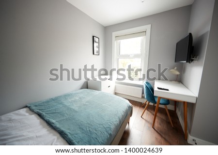 Bedroom in a modern house, looking towards window